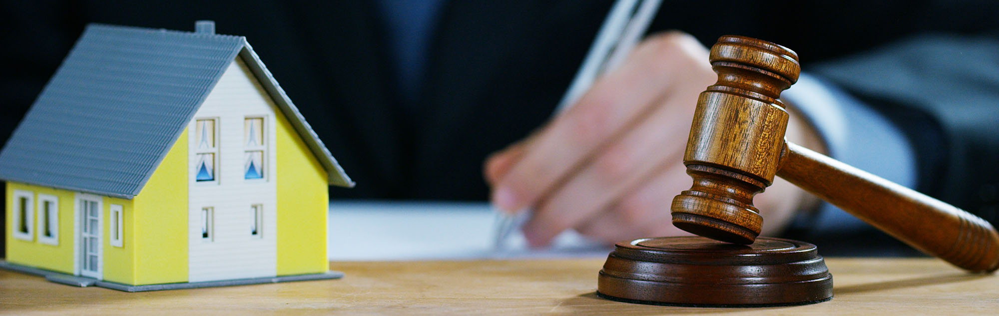 Conceptual Estate Image of a Gavel and Miniature House